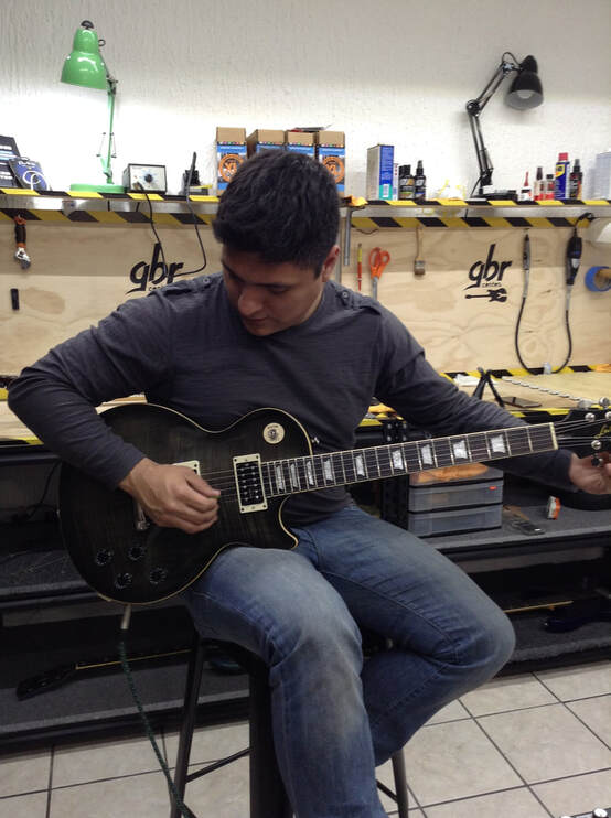 Guitarist adjusting guitar strings